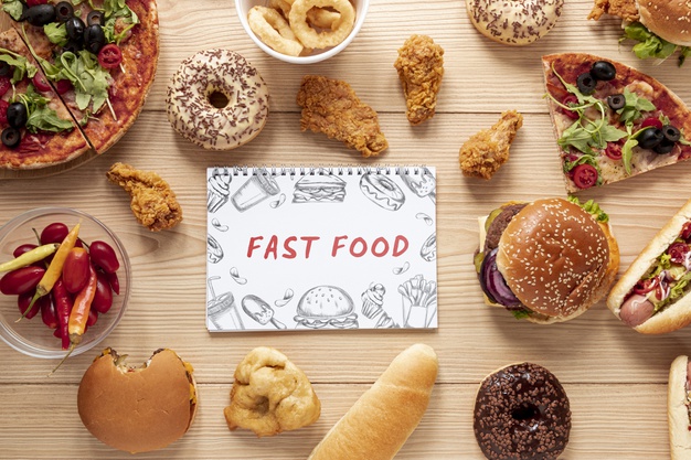 Top view of delicious fast food on wooden table Free Psd