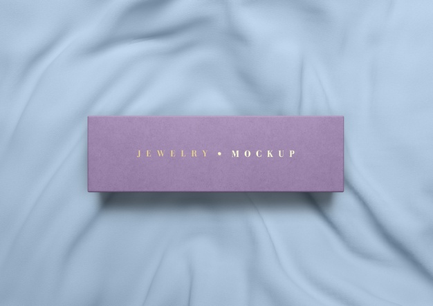 Flat lay pink box on silk fabric Free Psd